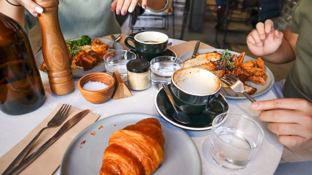 People enjoying brunch food in a café