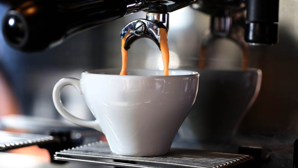 Coffee being poured in espresso machine